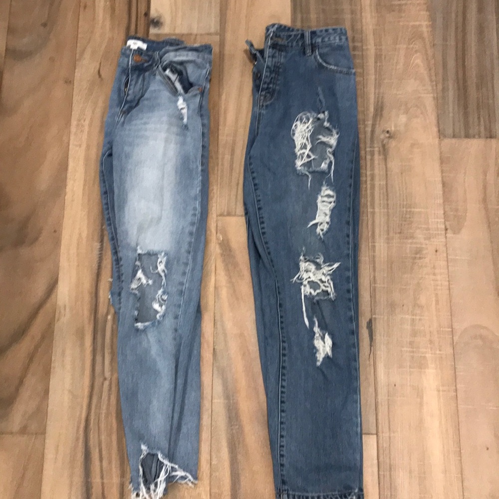 Two pairs of denim jeans with holes